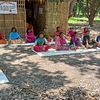 Indien: Kinder sitzen auf dem Boden und machen Yoga